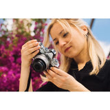 Photographer using the Nikon Z fc Black Mirrorless Camera with 16–50mm VR Lens